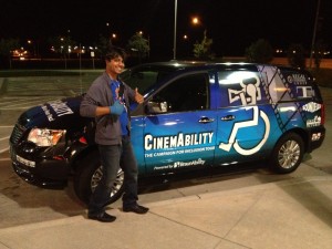 Graphic Artist & "Cine" logo designer stands with his work on "Cine" the Van!